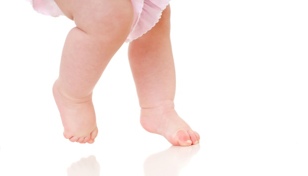 infant walking on tiptoes